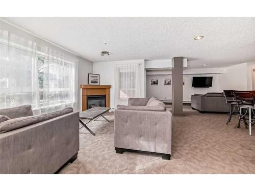 312-5115 Richard Road Sw, Calgary, AB - Indoor Photo Showing Living Room With Fireplace