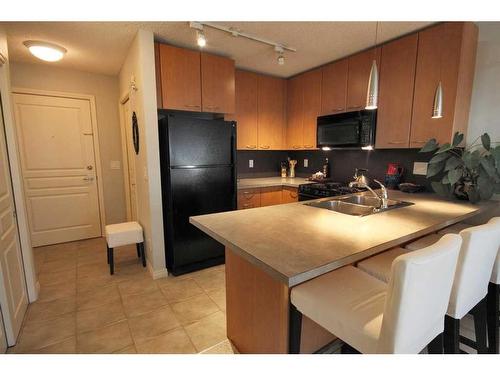 312-5115 Richard Road Sw, Calgary, AB - Indoor Photo Showing Kitchen With Double Sink