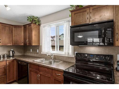 214 Panamount Way Nw, Calgary, AB - Indoor Photo Showing Kitchen With Double Sink