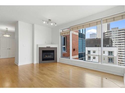 1501-910 5 Avenue Sw, Calgary, AB - Indoor Photo Showing Living Room With Fireplace