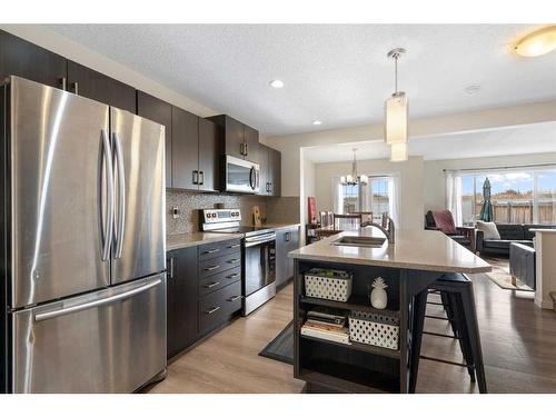 302 River Heights Crescent, Cochrane, AB - Indoor Photo Showing Kitchen With Upgraded Kitchen