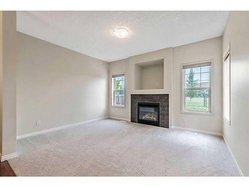 32 Silverado Saddle Court Sw, Calgary, AB - Indoor Photo Showing Living Room With Fireplace