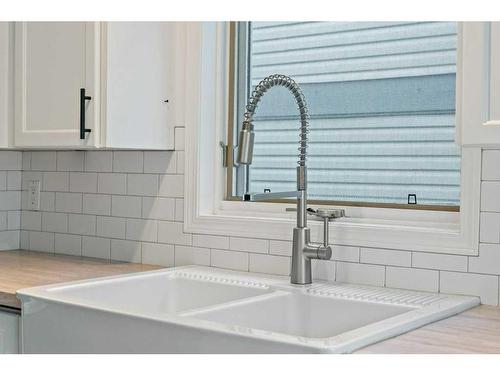 105 Patina Park Sw, Calgary, AB - Indoor Photo Showing Kitchen With Double Sink