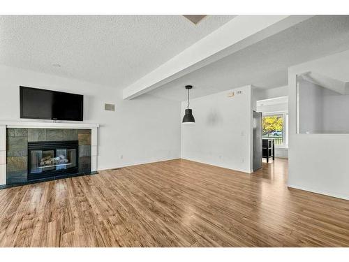 105 Patina Park Sw, Calgary, AB - Indoor Photo Showing Living Room With Fireplace