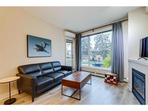 215-3600 15A Street Sw, Calgary, AB - Indoor Photo Showing Living Room With Fireplace