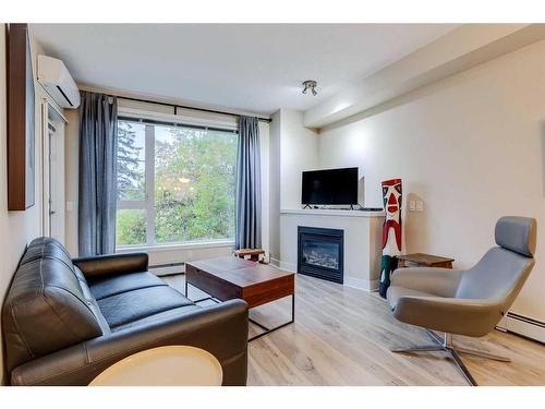 215-3600 15A Street Sw, Calgary, AB - Indoor Photo Showing Living Room With Fireplace