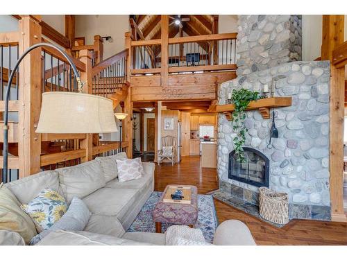 100-352246 242 Avenue West, Rural Foothills County, AB - Indoor Photo Showing Living Room With Fireplace