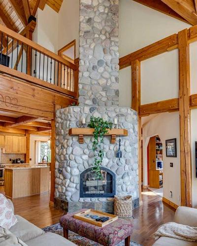 100-352246 242 Avenue West, Rural Foothills County, AB - Indoor Photo Showing Living Room With Fireplace