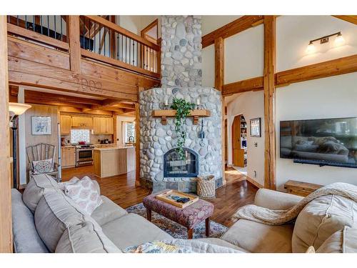 100-352246 242 Avenue West, Rural Foothills County, AB - Indoor Photo Showing Living Room With Fireplace