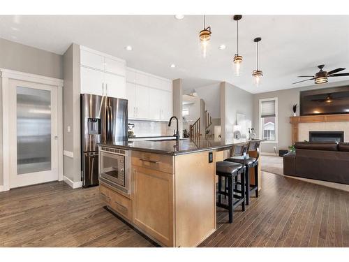 421 River Heights Drive, Cochrane, AB - Indoor Photo Showing Kitchen With Fireplace With Upgraded Kitchen