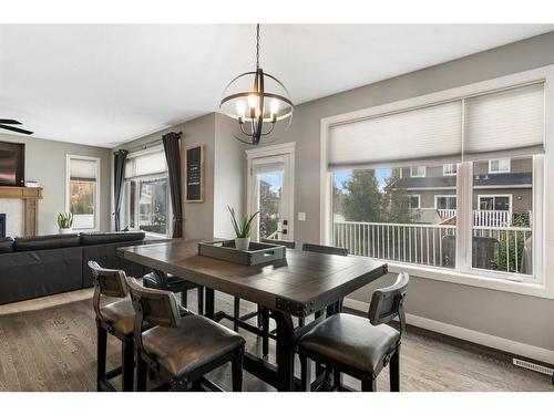 421 River Heights Drive, Cochrane, AB - Indoor Photo Showing Dining Room With Fireplace