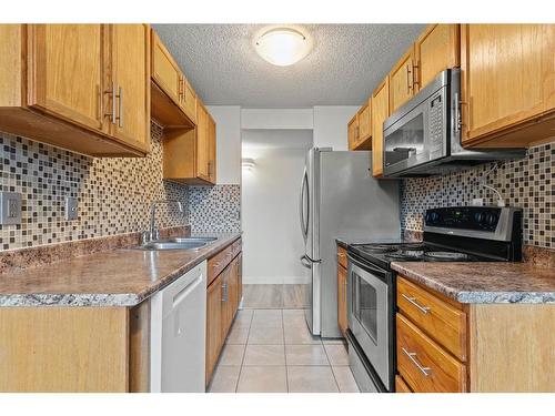 401-11620 Elbow Drive Sw, Calgary, AB - Indoor Photo Showing Kitchen With Stainless Steel Kitchen With Double Sink