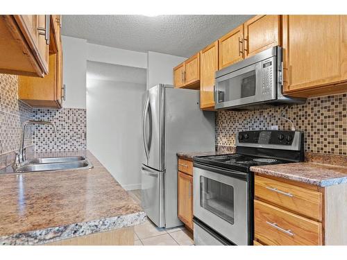 401-11620 Elbow Drive Sw, Calgary, AB - Indoor Photo Showing Kitchen With Double Sink