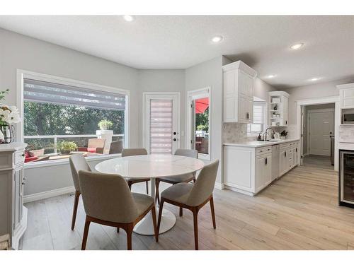 145 Candle Place Sw, Calgary, AB - Indoor Photo Showing Dining Room With Fireplace