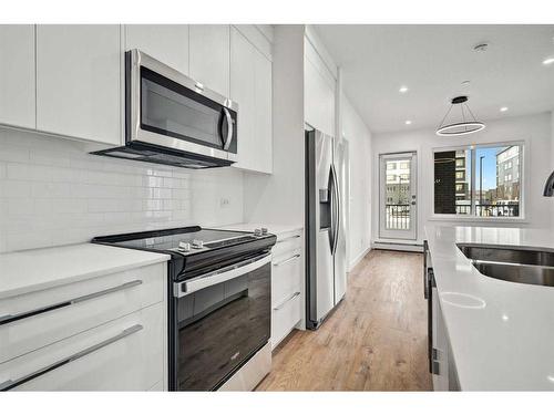 3113-111 Wolf Creek Drive Se, Calgary, AB - Indoor Photo Showing Kitchen With Stainless Steel Kitchen With Double Sink With Upgraded Kitchen