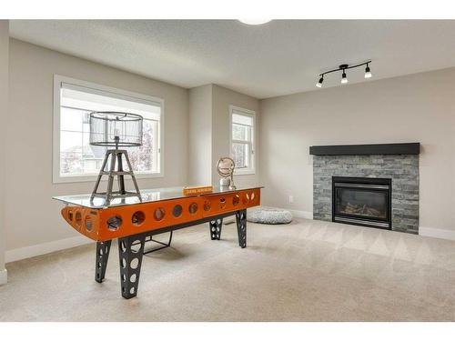 73 Crystal Shores Crescent, Okotoks, AB - Indoor Photo Showing Other Room With Fireplace