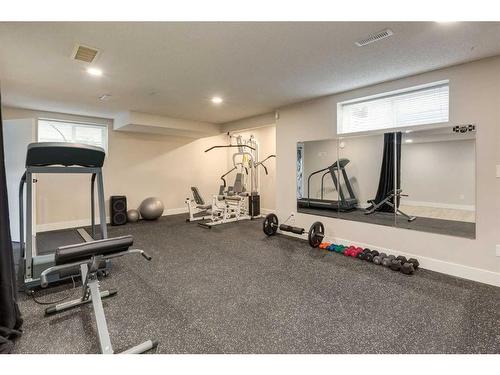 73 Crystal Shores Crescent, Okotoks, AB - Indoor Photo Showing Gym Room