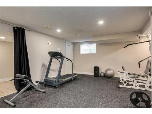 73 Crystal Shores Crescent, Okotoks, AB - Indoor Photo Showing Gym Room