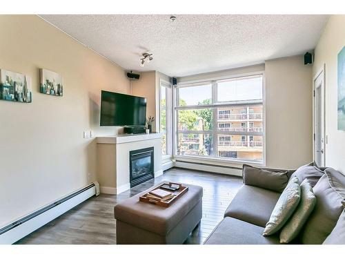 320-315 24 Avenue Sw, Calgary, AB - Indoor Photo Showing Living Room With Fireplace