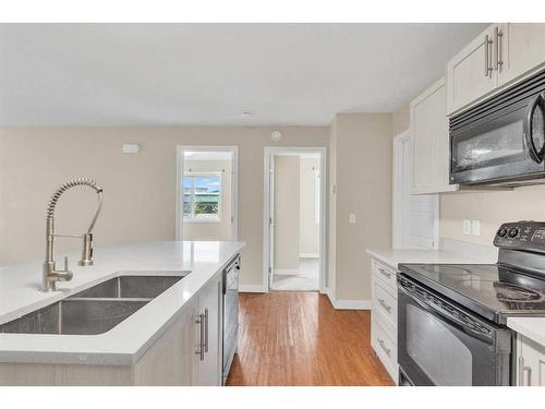 2101-2781 Chinook Winds Drive Sw, Airdrie, AB - Indoor Photo Showing Kitchen With Double Sink