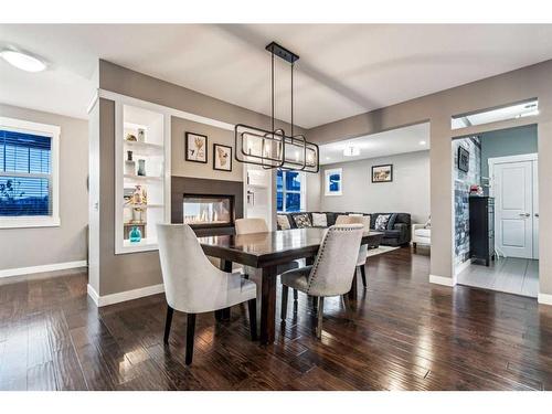 217 Rainbow Falls Glen, Chestermere, AB - Indoor Photo Showing Dining Room With Fireplace