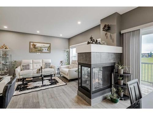 32 Legacy Cove Se, Calgary, AB - Indoor Photo Showing Living Room With Fireplace