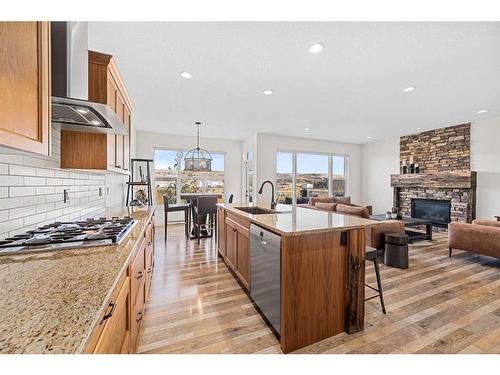 30 Riviera View South, Cochrane, AB - Indoor Photo Showing Kitchen With Fireplace With Upgraded Kitchen