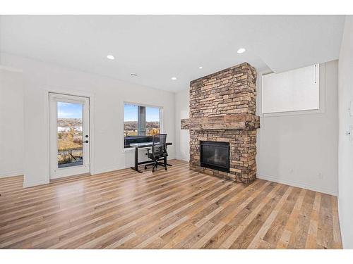 30 Riviera View South, Cochrane, AB - Indoor Photo Showing Living Room With Fireplace