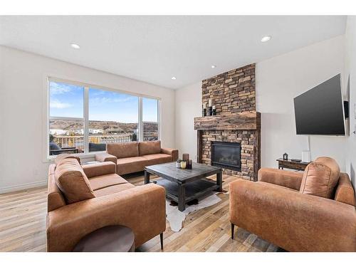 30 Riviera View South, Cochrane, AB - Indoor Photo Showing Living Room With Fireplace