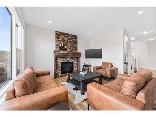 30 Riviera View South, Cochrane, AB - Indoor Photo Showing Living Room With Fireplace