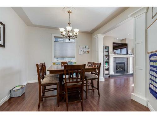 39 Rockcliff Landing Nw, Calgary, AB - Indoor Photo Showing Dining Room With Fireplace