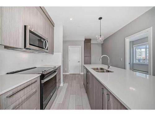 3213-111 Wolf Creek Drive Se, Calgary, AB - Indoor Photo Showing Kitchen With Double Sink With Upgraded Kitchen