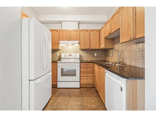 304-8 Prestwick Pond Terrace Se, Calgary, AB - Indoor Photo Showing Kitchen With Double Sink