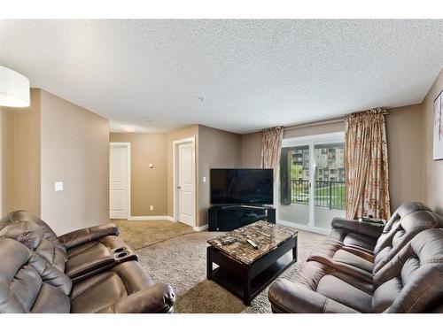 313-195 Kincora Glen Road Nw, Calgary, AB - Indoor Photo Showing Living Room