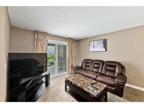 313-195 Kincora Glen Road Nw, Calgary, AB - Indoor Photo Showing Living Room