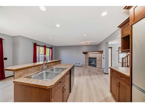 455 Cranston Drive Se, Calgary, AB - Indoor Photo Showing Kitchen With Fireplace With Double Sink