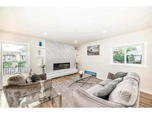 103 Olympia Drive Se, Calgary, AB - Indoor Photo Showing Living Room With Fireplace