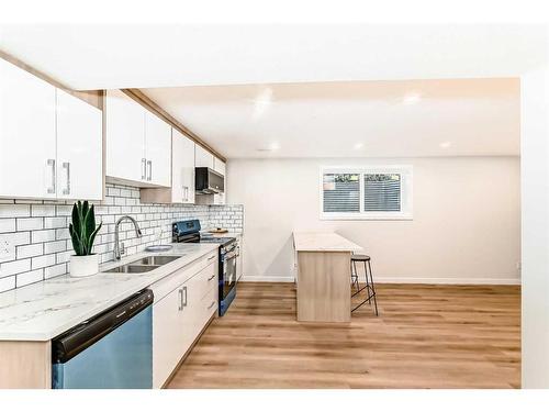 103 Olympia Drive Se, Calgary, AB - Indoor Photo Showing Kitchen With Double Sink