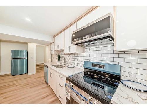 103 Olympia Drive Se, Calgary, AB - Indoor Photo Showing Kitchen With Double Sink