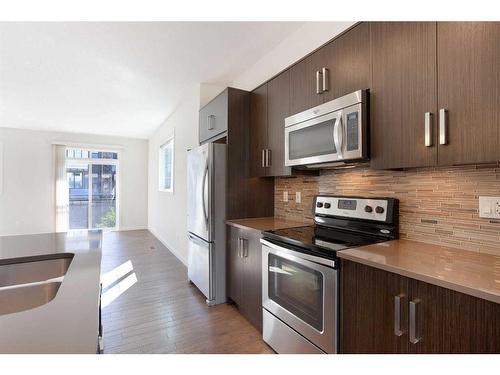 16 Walden Walk Se, Calgary, AB - Indoor Photo Showing Kitchen With Stainless Steel Kitchen With Double Sink