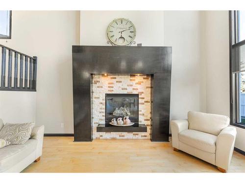 245 Chapalina Mews Se, Calgary, AB - Indoor Photo Showing Living Room With Fireplace