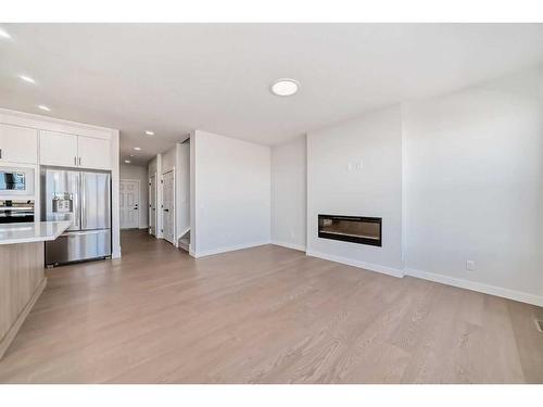 37 Amblefield View Nw, Calgary, AB - Indoor Photo Showing Kitchen With Fireplace