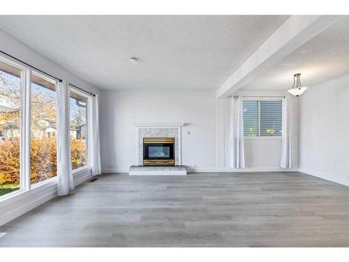 345 Falshire Drive Ne, Calgary, AB - Indoor Photo Showing Living Room With Fireplace