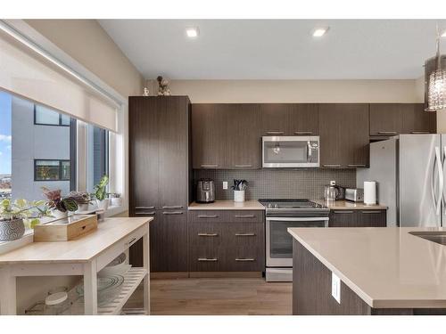 701-218 Sherwood Square Nw, Calgary, AB - Indoor Photo Showing Kitchen With Stainless Steel Kitchen