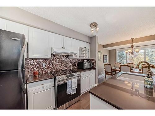 125 Cougarstone Place Sw, Calgary, AB - Indoor Photo Showing Kitchen With Upgraded Kitchen