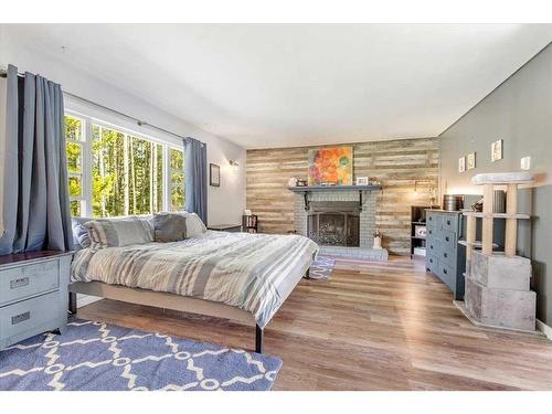 71067 Township Road 38-0, Rural Clearwater County, AB - Indoor Photo Showing Bedroom With Fireplace