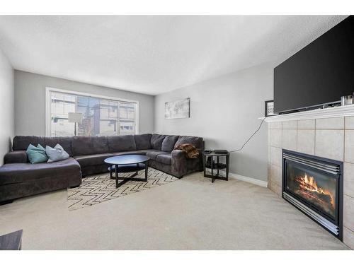 51 Crystal Shores Cove, Okotoks, AB - Indoor Photo Showing Living Room With Fireplace