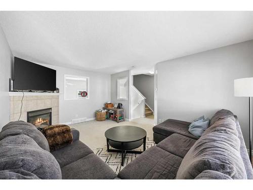 51 Crystal Shores Cove, Okotoks, AB - Indoor Photo Showing Living Room With Fireplace