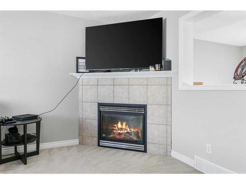 51 Crystal Shores Cove, Okotoks, AB - Indoor Photo Showing Living Room With Fireplace