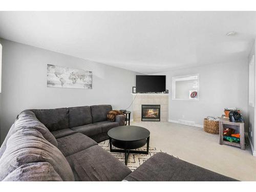 51 Crystal Shores Cove, Okotoks, AB - Indoor Photo Showing Living Room With Fireplace